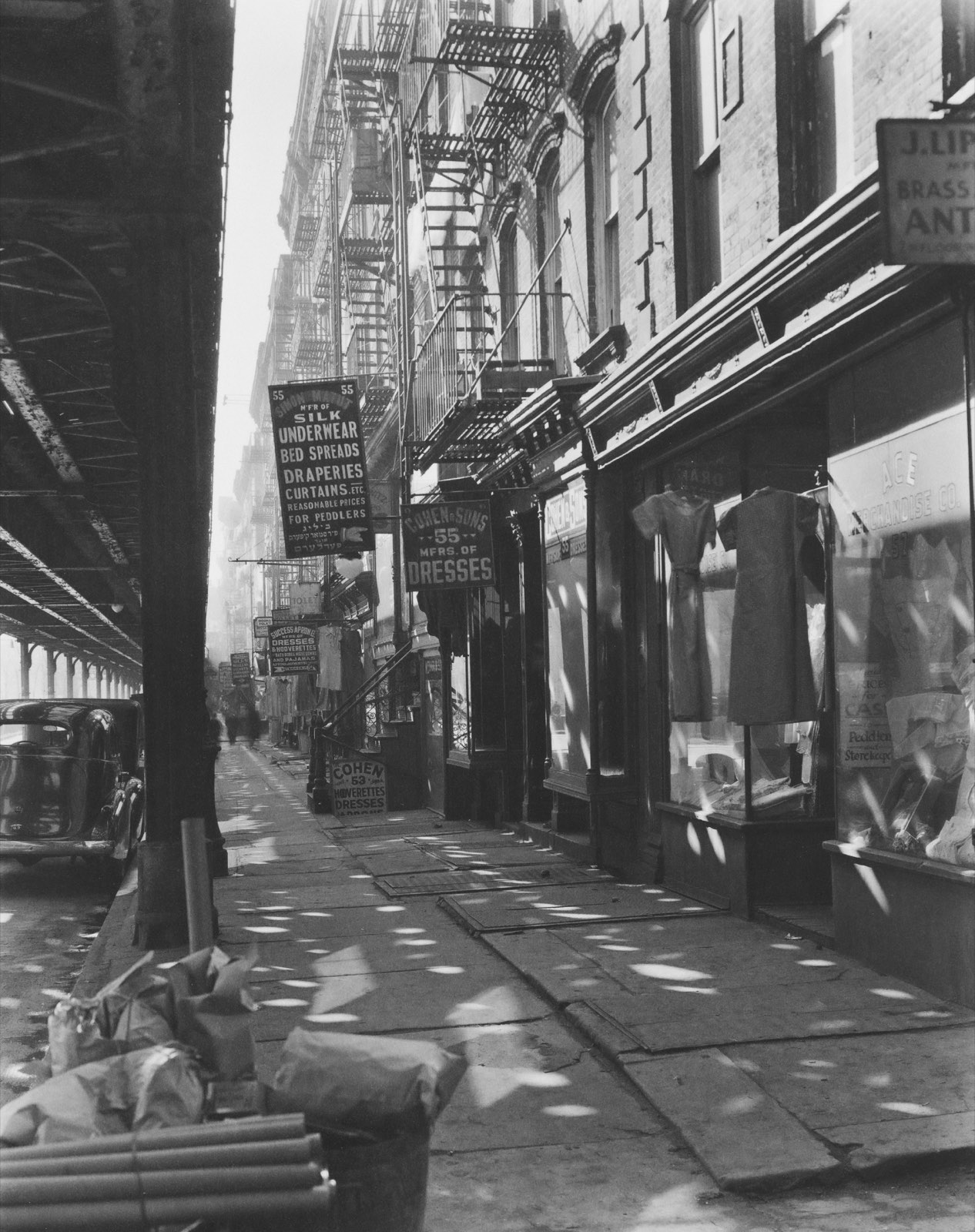 An archival city street scene with period storefronts